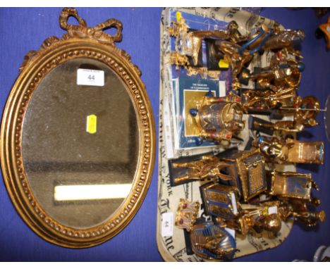 A quantity of Franklin Mint Tutankhamun gilded models, including a marriage chest, a lion's head, a sarcophagus, a cobra, etc