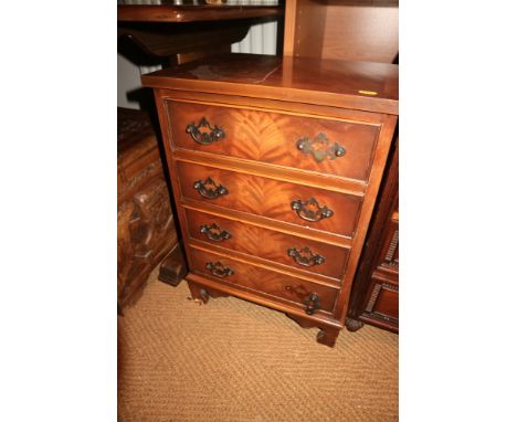 A figured mahogany and banded chest of four drawers, on bracket feet, 10 1/2" wide