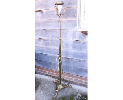A 20th century brass standard lamp, on tripod support