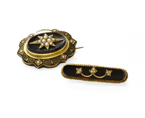 An Onyx, Seed Pearl and Enamel Mourning Brooch, a cluster of seed pearls in a yellow star setting, to an oval onyx plaque wit