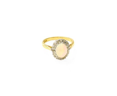 An 18 Carat Gold Opal and Diamond Cluster Ring, the oval cabochon opal within a border of eight-cut diamonds, in white claw s