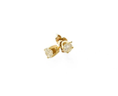 A Pair of Diamond Solitaire Earrings, the round brilliant cut diamonds in yellow four claw settings, total estimated diamond 