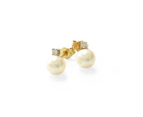 A Pair of Cultured Pearl and Diamond Earrings, the cultured pearls surmounted by a round brilliant cut diamond in a white fou