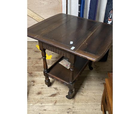 A antique drop leaf table on castors with shelf under. 68cm x 44cm closed size. No shipping. 