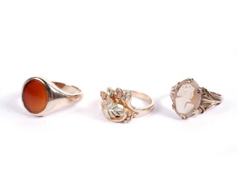 Three rings, comprising: a 9ct gold and cameo ring, size N; a 9ct gold and carnelian signet ring, size P; and a yellow-metal 