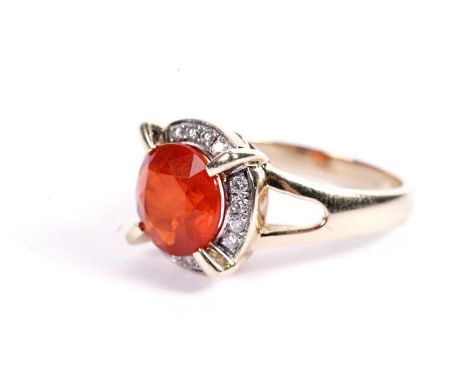 A fire opal and diamond cluster dress ring, in yellow gold, stamped "14K", size R, 6.6g gross.