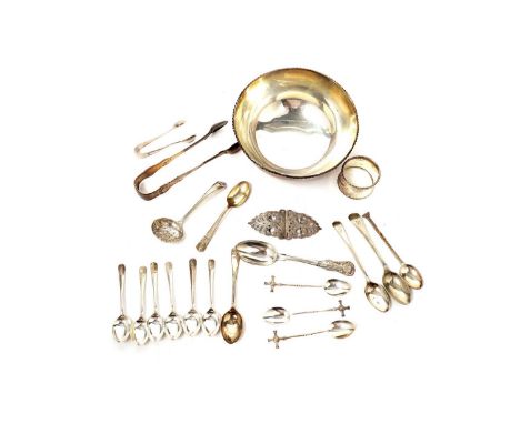 A selection of silver items, including; silver teaspoons; sugar tongs; a napkin ring; a belt buckle; and other items; a bowl 