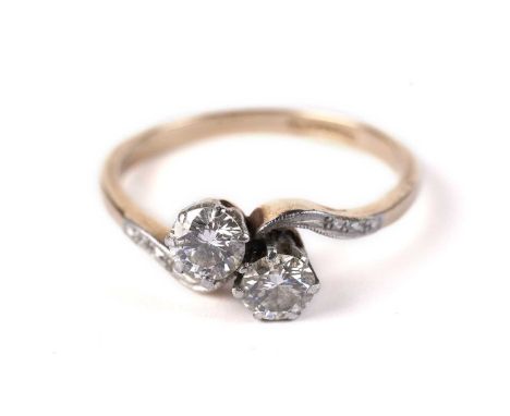A two-stone diamond crossover pattern ring, on a gold shank, stamped "Plat &amp; 18ct", size N, 2.7g gross.