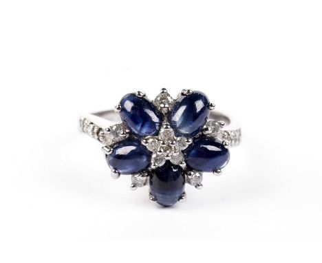 A sapphire and diamond dress ring, set with sapphire cabochons and brilliant cut diamonds, in 9ct white gold mount and shank,