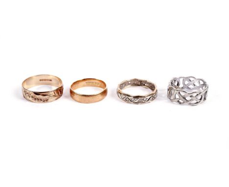 A 9ct white gold Celtic wedding band, of pierced design, size K, 3.6g gross; two 9ct yellow gold wedding bands, 4.8g gross; a