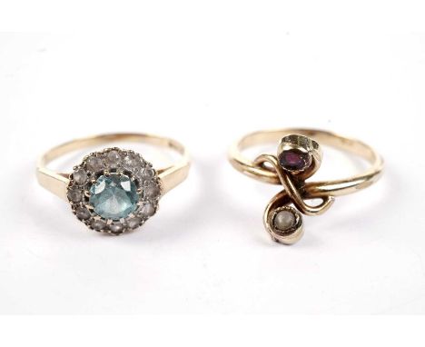 A blue topaz cluster ring, on an 18ct gold shank, size P, 3.1g gross; and a gilt-metal twist-set pearl and ruby ring, size O.