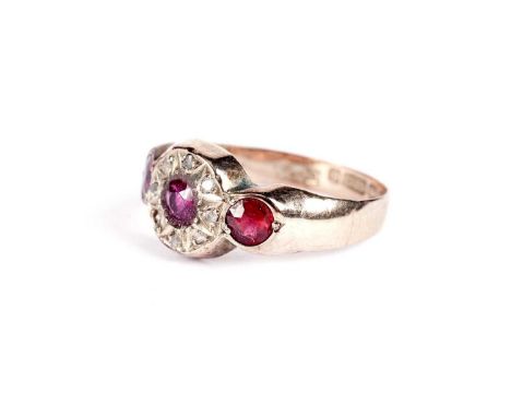 An Edwardian ruby and diamond ring, with faceted red stone shoulders, replacement 9ct yellow gold shank, size P, 1.5g gross.