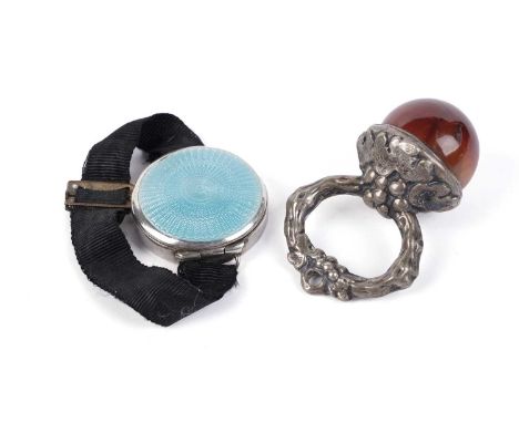 An agate and silver-coloured metal child's teether; and a silver and enamel wrist compact.