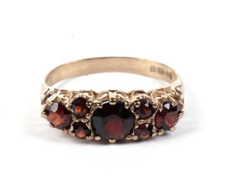 A seven stone-garnet ring, in 9ct yellow gold mount and shank, ring size O, 2.2g gross.