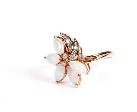 An opal and diamond dress ring, in a stylized flower pattern, stamped "750", surface tests as 18ct, size S, 5g gross.
