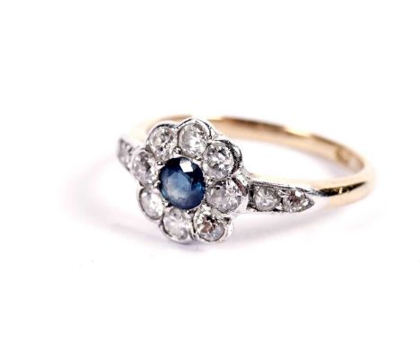 A sapphire and diamond flower pattern ring, on a gold shank, stamped "18", size L, 3.1g gross, second quarter 20th Century.
