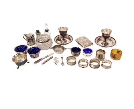 A selection of silver items, to include: a mustard pot with pierced fish and scroll decoration; a tea strainer with foliate s
