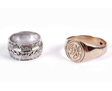 A 9ct white gold wedding band, engraved with star motifs, approximately size I, 6.2g gross; and a monogrammed yellow gold sig