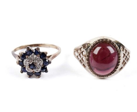 A garnet cabochon ring, in 9ct yellow gold, size Q, 2.9g gross; and a sapphire and diamond cluster ring, in yellow gold, stam