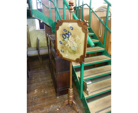 A Willian IV mahogany pole screen raised on a carved tripod base, the handworked tapestry panel showing a botanical bouquet