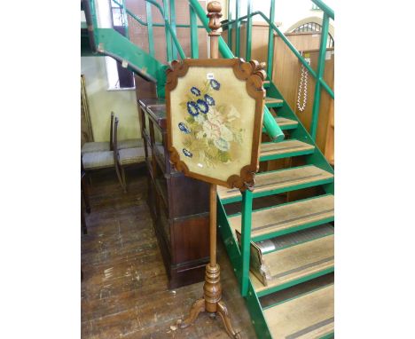 A Willian IV mahogany pole screen raised on a carved tripod base, the handworked tapestry panel showing a botanical bouquet