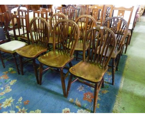 A set of five elm and beechwood hoop and stick back kitchen chairs raised on turned supports united by stretchers, together w