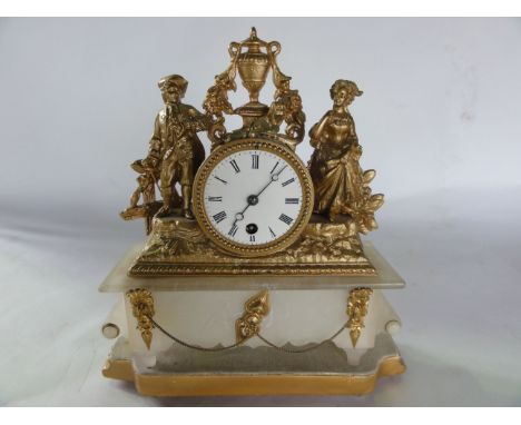 A mid 19th century alabaster and gilded spelter mantle clock, the movement between two figures in 18th century dress