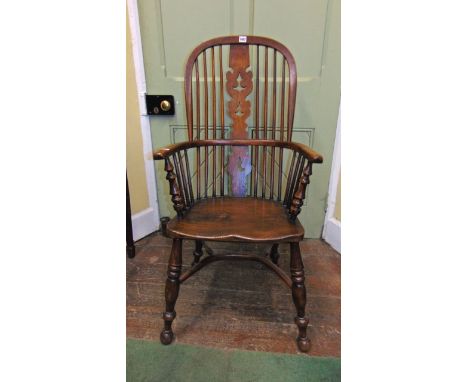 A 19th century Windsor elm back elbow chair with comb seat, with shaped and pierced centre splat, turned supports and crinoli