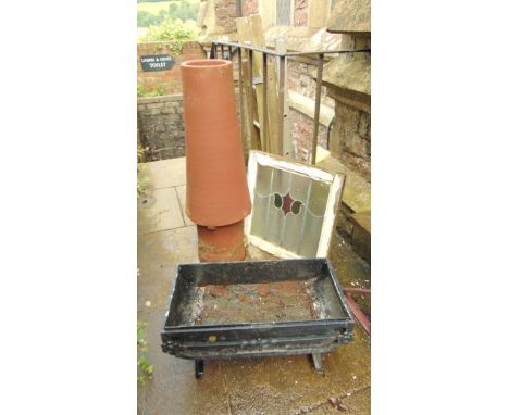 A tall reclaimed terracotta chimney pot of conical form, together with a cast iron garden planter and a 1930s pine framed cas