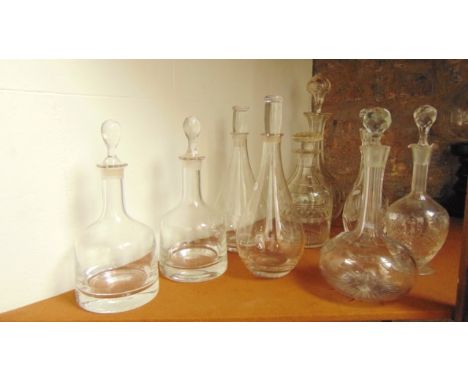 A selection of nine cut glass decanters to include  a Shaft & Globe example with star cut detail, a pair of mallet shaped dec