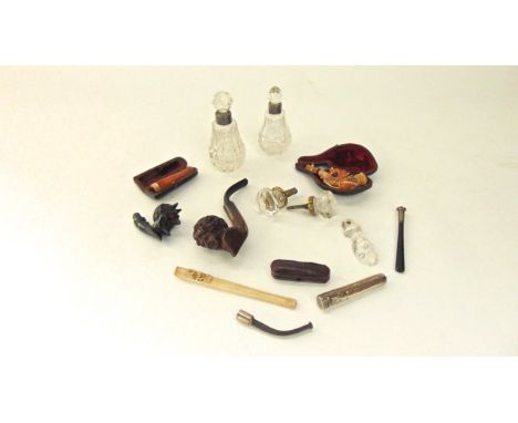 A carved burr cherrywood pipe with female head detail, meerschaum charcoal holder, cut glass bottles, etc