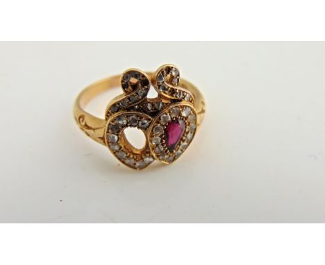 A Victorian twin heart ring, set with a pear-shaped untested ruby/tourmaline, the twin stone lacking, highlighted within a sc