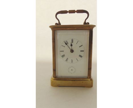 A late 19th century brass carriage clock with enamelled dial, the movement of 8 day duration with bell alarm