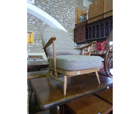 An Ercol light beechwood low hoop and stick back open armchair with loose seat cushions