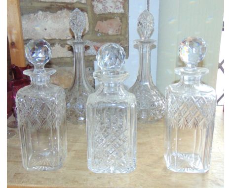 A good quality pair of tall cased decanters with diamond and fan cut detail set beneath cut shoulders and faceted globular st