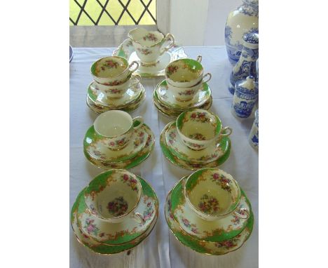 A collection of Paragon China Rockingham pattern tea wares with green, gilt and floral decoration comprising milk jug, cake p