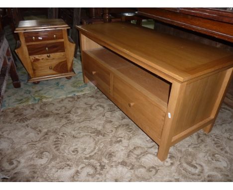 A low contemporary light oak TV stand of rectangular form incorporating two frieze drawers with exposed dove tail constructio