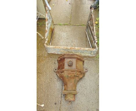 A reclaimed Victorian cast iron cistern/sink bracket in three sections with decorative pierced detail and trailing swag panel