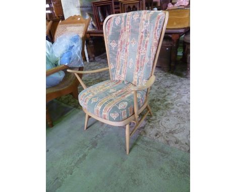 An Ercol light beechwood high hoop and stick back open armchair