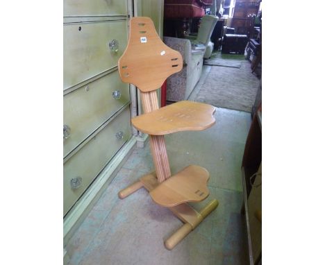 A contemporary light beechwood adjustable posture chair