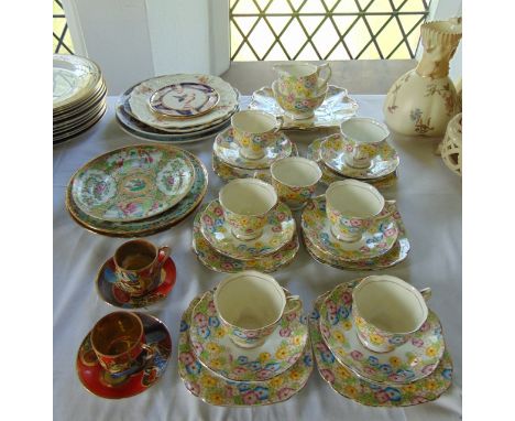 A collection of Royal Albert Crown China teawares in the Art Deco style with pink, blue and yellow floral detail comprising m