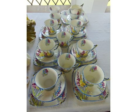 A collection of Royal Albert Crown China tea wares in the Art Deco manner with painted yellow, blue and purple stylised gladi