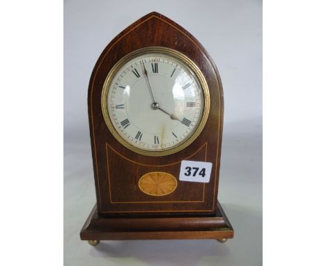 An Edwardian mahogany mantle clock in a lancet shaped case with inlaid detail, 8 day timepiece and convex dial