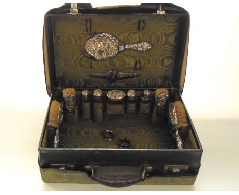 A cased Edwardian silver travelling dressing table set, William Devenport, Birmingham, 1908, comprising: a hand mirror, two h