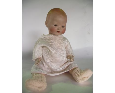 A German bisque headed doll by Armand Marseille marked to neck A.M Germany 351./4/K with painted facial detail and weighted e