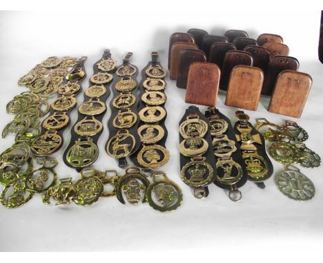 A collection of horse brasses to include seven assemblies presented on leather wall hanging straps, further loose example tog