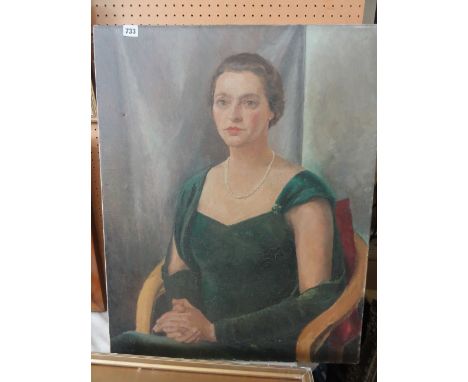 A mid-20th century oil painting on canvas, half length portrait of a lady in a green dress and pearl necklace, seated, 77cm x