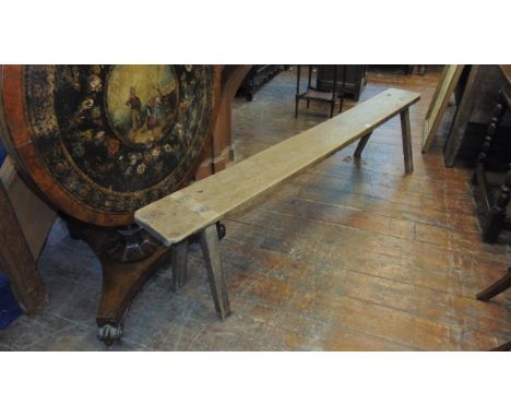 An oak bench, raised on four stick supports, 205 cm 