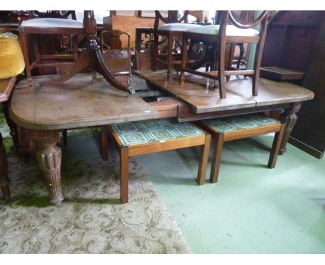 A substantial Victorian oak wind out extending dining table with moulded outline and rounded corners and two additional leave