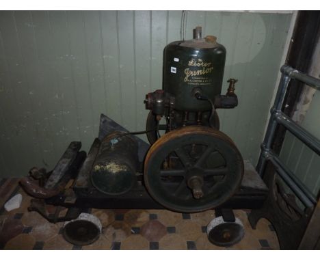 The Lister Junior stationary engine number 212690, 3hp, 600rpm, mounted on a timber cart/chassis with cast iron wheels